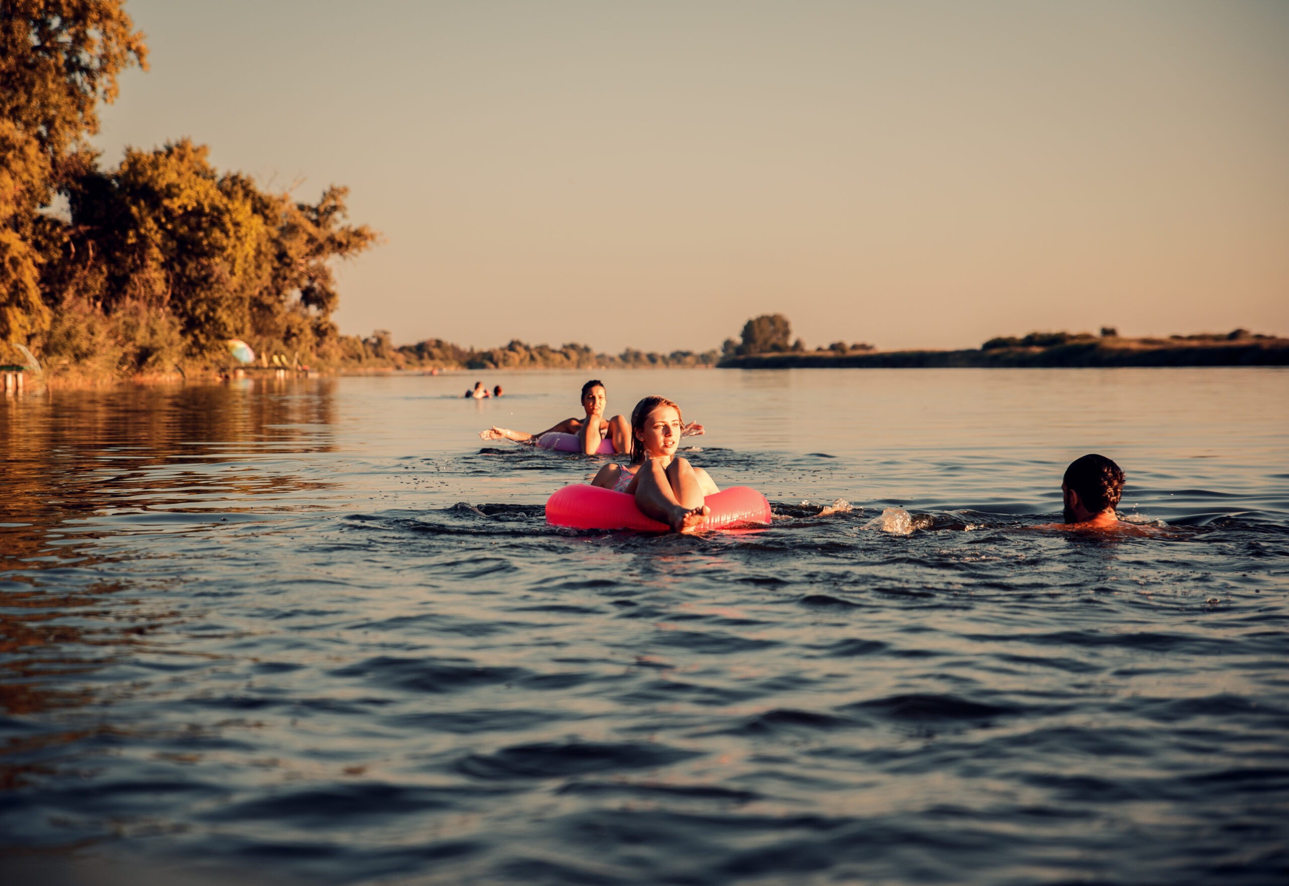 Friends enjoying a summer day swimming at the lake. Florence