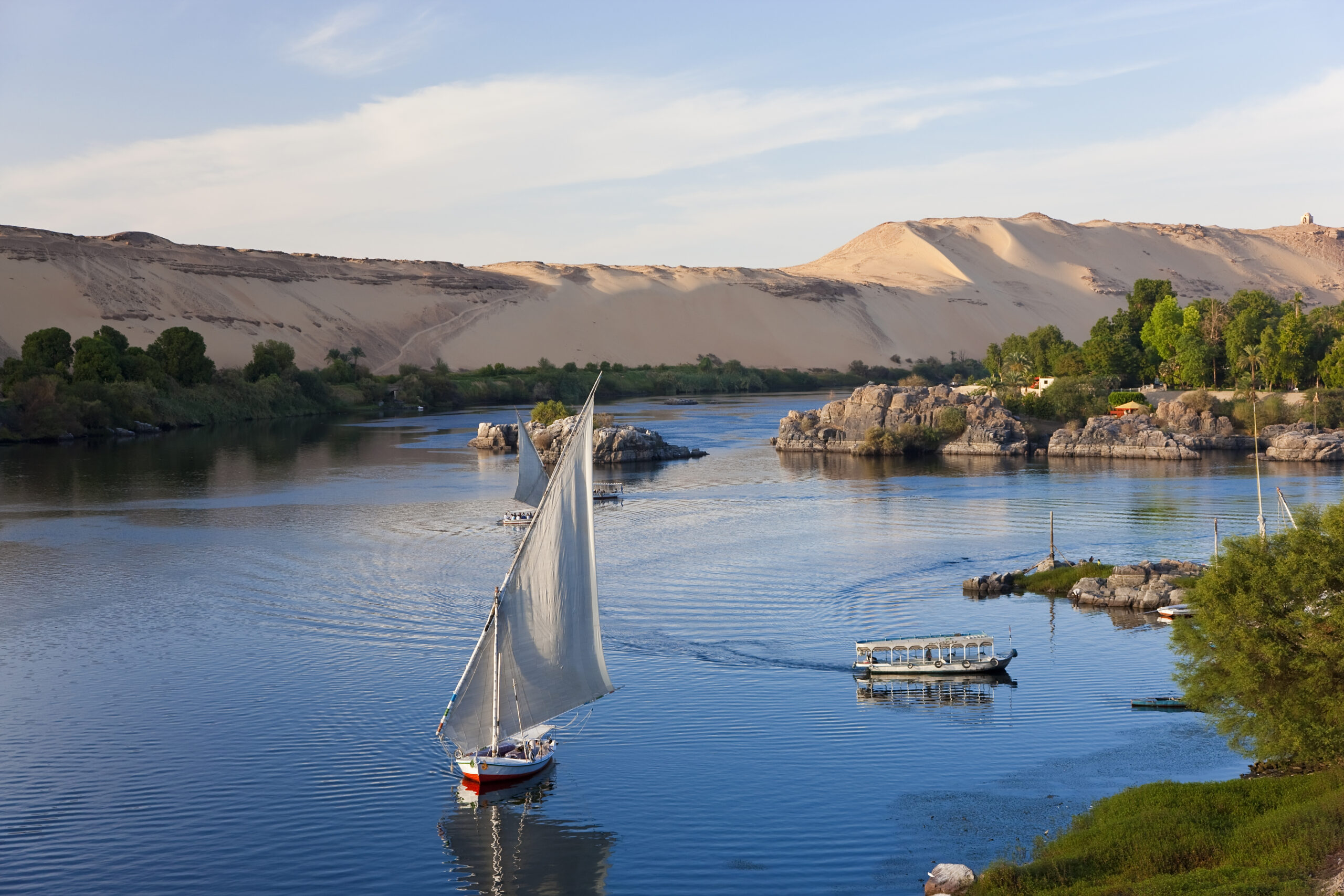 Egypt,High angle view of sailboats on a river, sand hills in the distance. Visit Florence